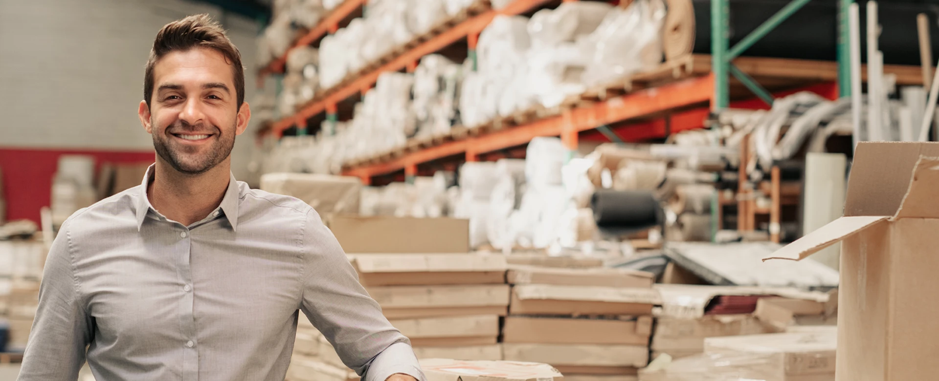 Warehouse worker looking at shipping boxes